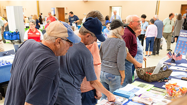 Senior citizens gather information from exhibitors at Senator Martin’s senior expo.
